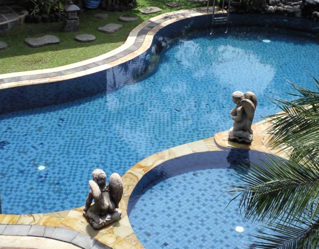Modern pool remodel featuring spa spillover, new tile, and ambient lighting in Denton, TX