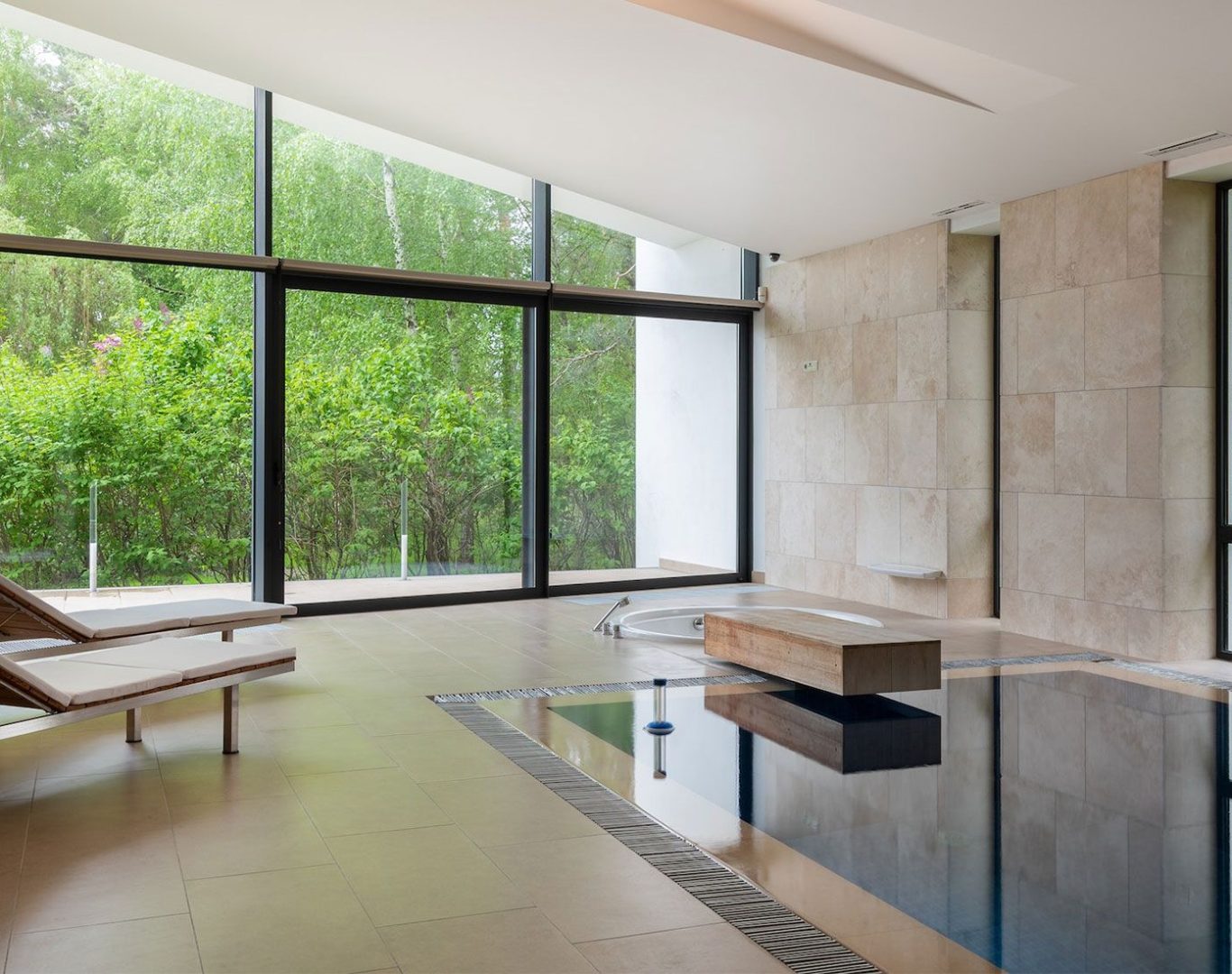 Modern pool remodel featuring spa spillover, new tile, and ambient lighting in Denton, TX