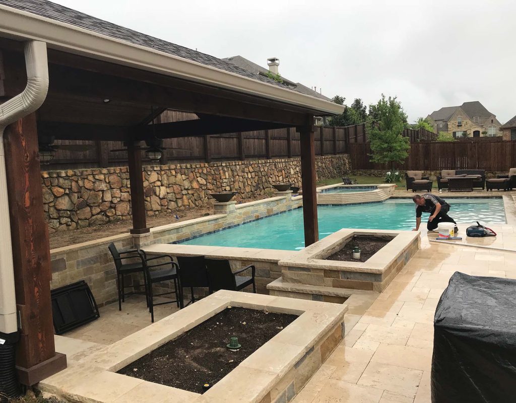 Modern pool remodel featuring spa spillover, new tile, and ambient lighting in Denton, TX
