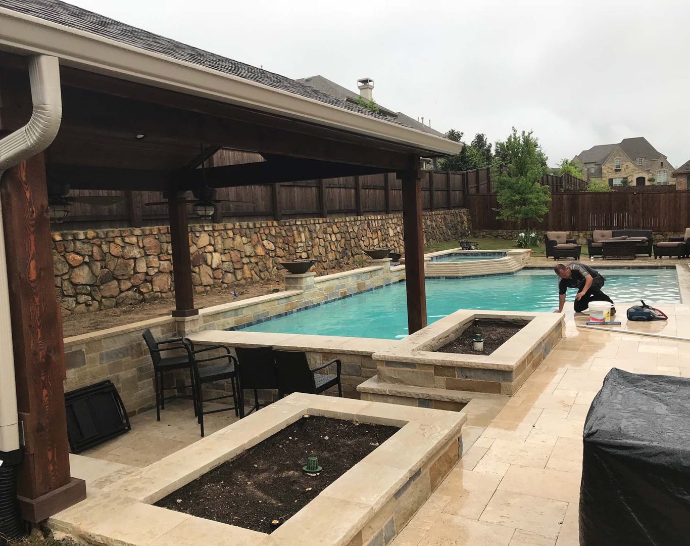 Modern pool remodel featuring spa spillover, new tile, and ambient lighting in Denton, TX