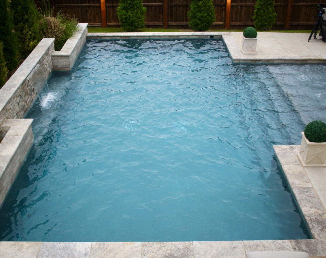 Maintenance log being completed by pool technician in Denton, TX backyard pool area