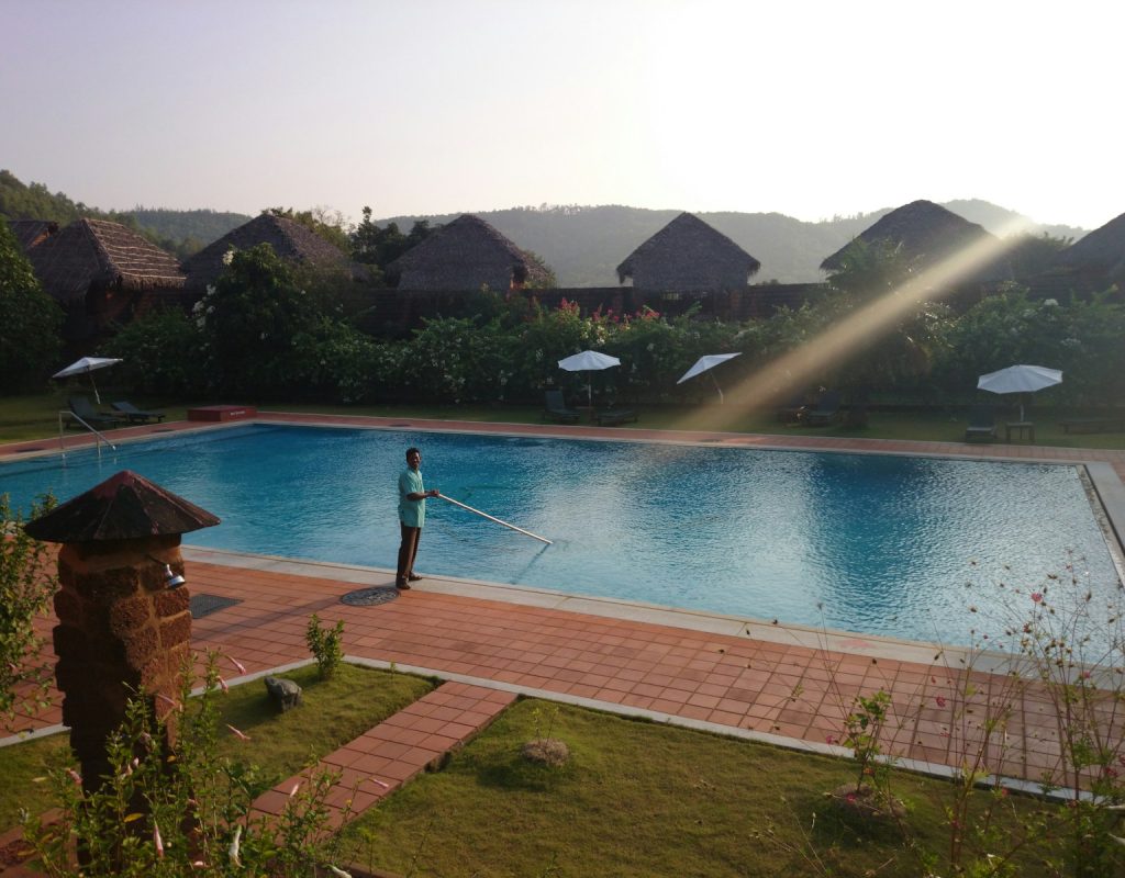 man cleaning pool in Lewisville, TX